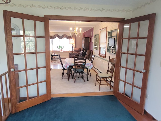dining area with french doors, carpet flooring, a chandelier, and baseboard heating