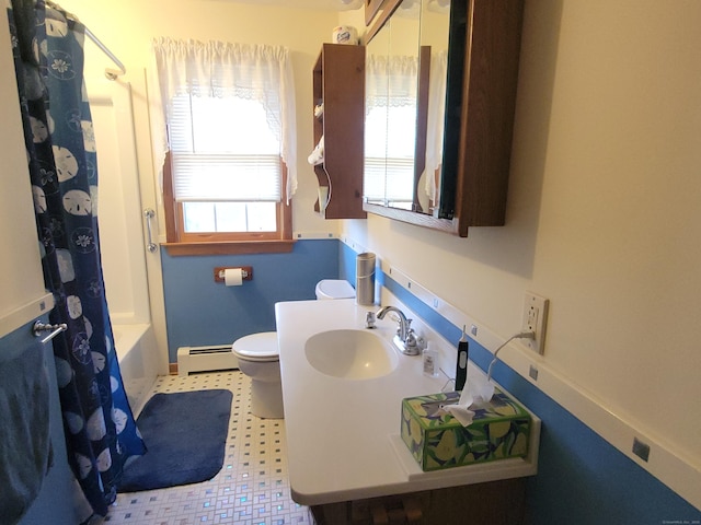 bathroom with shower / bath combination with curtain, baseboard heating, tile patterned floors, vanity, and toilet