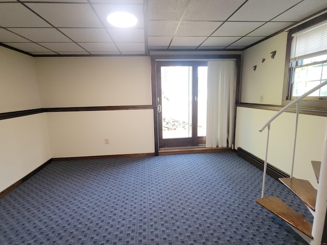 spare room with dark carpet, baseboards, baseboard heating, and a paneled ceiling