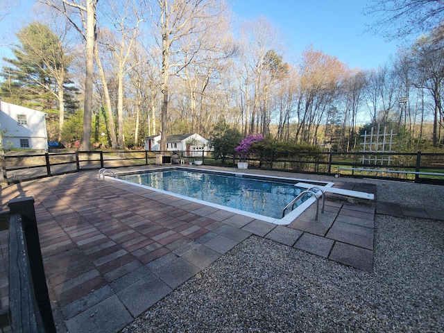 view of swimming pool featuring a fenced in pool, fence, and a patio