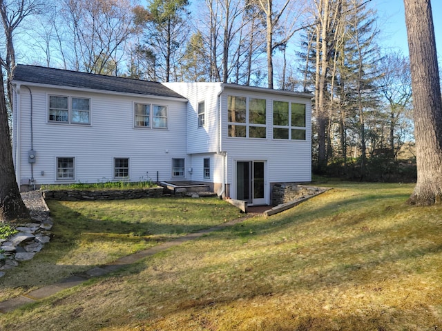 back of property featuring a yard