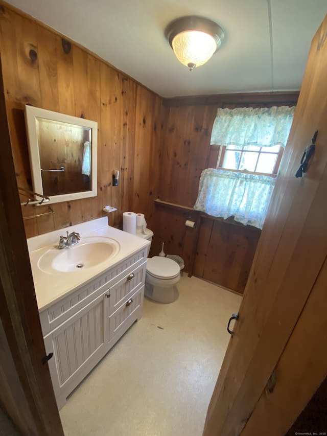 318 Billow Rd, Old Lyme, CT 06371 - half bathroom with wooden walls, toilet, and vanity