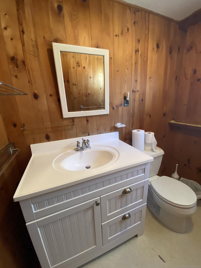 318 Billow Rd, Old Lyme, CT 06371 - bathroom featuring vanity, wooden walls, and toilet