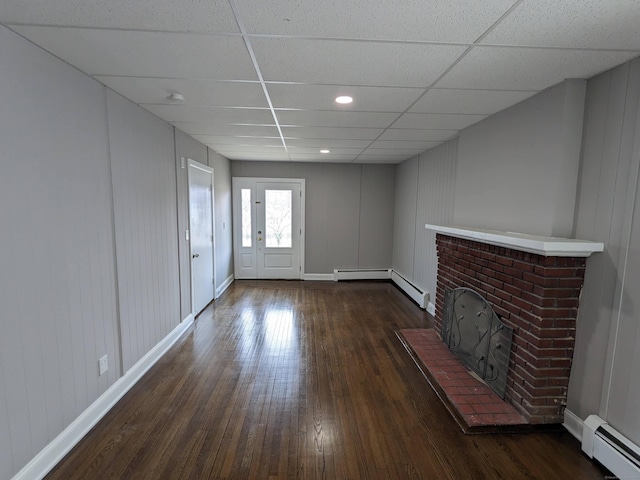 327 Center St, West Haven, CT 06516 - unfurnished living room with hardwood / wood-style floors, baseboards, a paneled ceiling, and a baseboard radiator