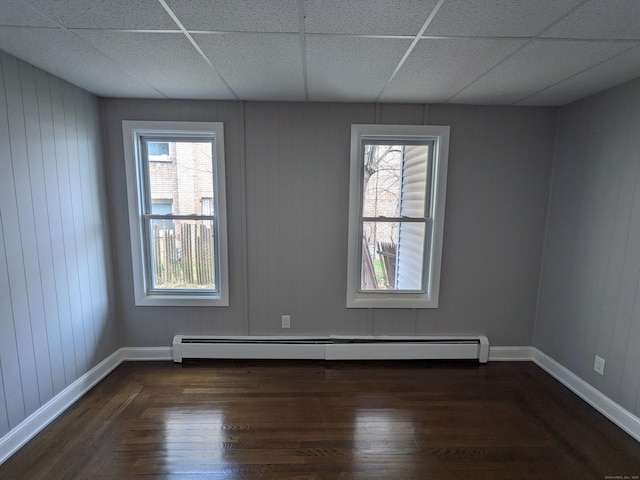 327 Center St, West Haven, CT 06516 - spare room featuring baseboards, a drop ceiling, dark wood-style floors, and a baseboard radiator