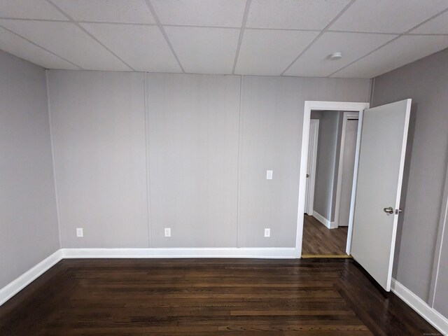 327 Center St, West Haven, CT 06516 - unfurnished bedroom featuring baseboards, dark wood-style floors, and a paneled ceiling
