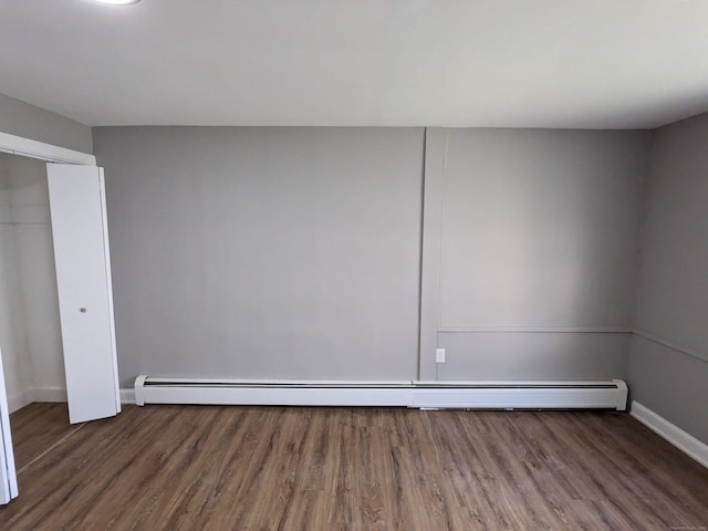 327 Center St, West Haven, CT 06516 - empty room with baseboards, a baseboard heating unit, and wood finished floors
