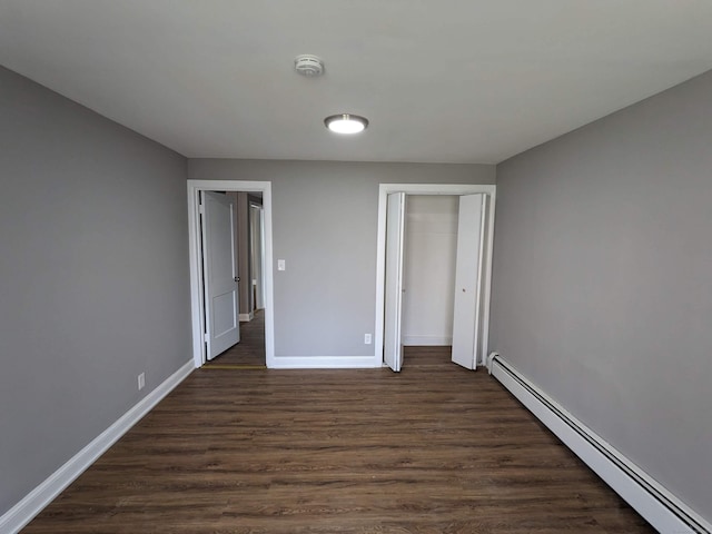 327 Center St, West Haven, CT 06516 - unfurnished bedroom with baseboards, a baseboard heating unit, dark wood-style floors, and a closet