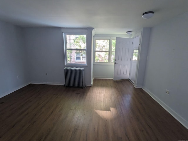 327 Center St, West Haven, CT 06516 - spare room featuring baseboards, radiator, dark wood-style floors, and a wealth of natural light