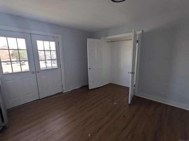 327 Center St, West Haven, CT 06516 - unfurnished bedroom with french doors, baseboards, and dark wood-style floors