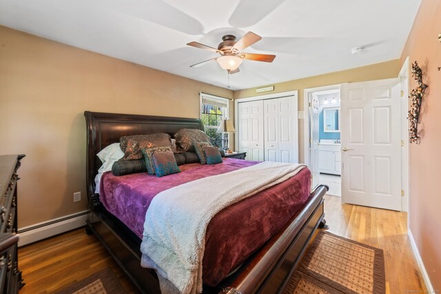 bedroom featuring a closet, ceiling fan, wood finished floors, and a baseboard radiator