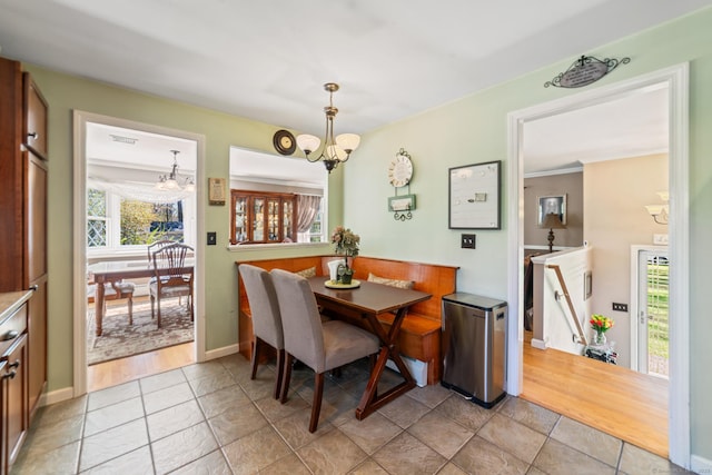 dining room featuring baseboards, a notable chandelier, and visible vents