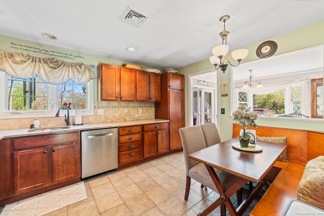 kitchen featuring a sink, light countertops, visible vents, and dishwasher