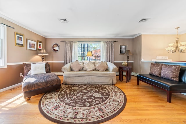 living area featuring visible vents, light wood finished floors, and a notable chandelier