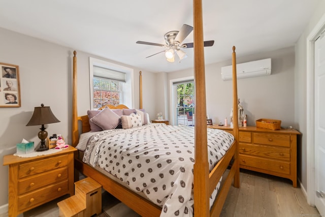 bedroom featuring a ceiling fan, a wall mounted AC, access to exterior, and light wood-style flooring