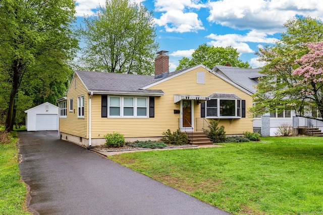 bungalow with a chimney, driveway, an outbuilding, a detached garage, and roof with shingles