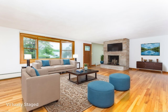 living room with a fireplace, a baseboard radiator, and wood finished floors
