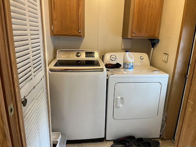 laundry area featuring separate washer and dryer and cabinet space