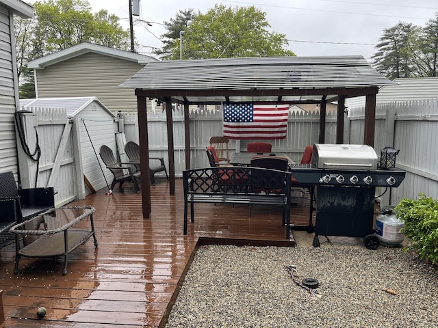 deck featuring a grill and a fenced backyard