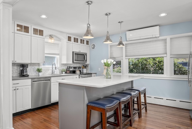29 Old Neversink Rd, Danbury, CT 06811 - kitchen featuring a kitchen breakfast bar, appliances with stainless steel finishes, tasteful backsplash, a wall mounted air conditioner, and a baseboard radiator