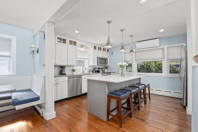 29 Old Neversink Rd, Danbury, CT 06811 - kitchen with plenty of natural light, a wall mounted AC, baseboard heating, and stainless steel appliances