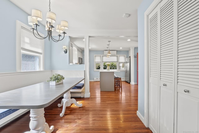 29 Old Neversink Rd, Danbury, CT 06811 - dining space with a baseboard heating unit, a notable chandelier, wood finished floors, and a wealth of natural light