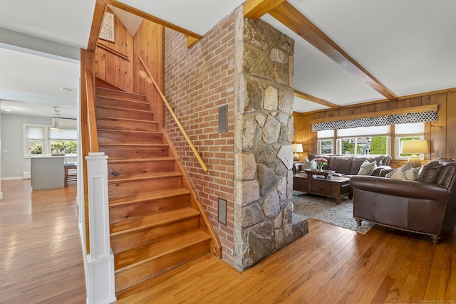 29 Old Neversink Rd, Danbury, CT 06811 - stairway with baseboards, beam ceiling, wooden walls, and hardwood / wood-style floors