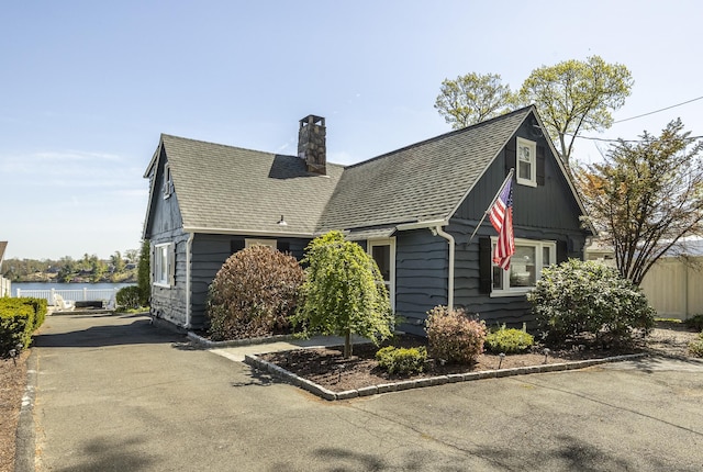 29 Old Neversink Rd, Danbury, CT 06811 - view of side of home featuring a water view, fence, a chimney, and roof with shingles