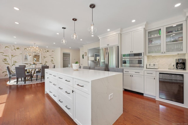 kitchen with hanging light fixtures, stainless steel appliances, and recessed lighting