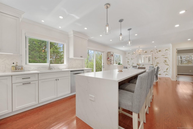 kitchen with a sink, dishwasher, and a healthy amount of sunlight