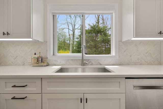 kitchen featuring a sink, light countertops, white cabinets, and dishwasher