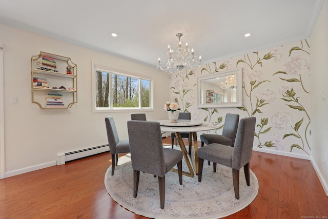 dining area with crown molding, baseboards, a baseboard heating unit, and a chandelier