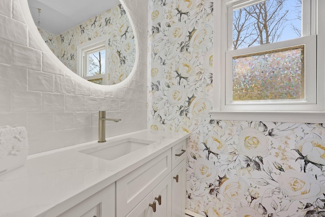 bathroom featuring wallpapered walls and vanity