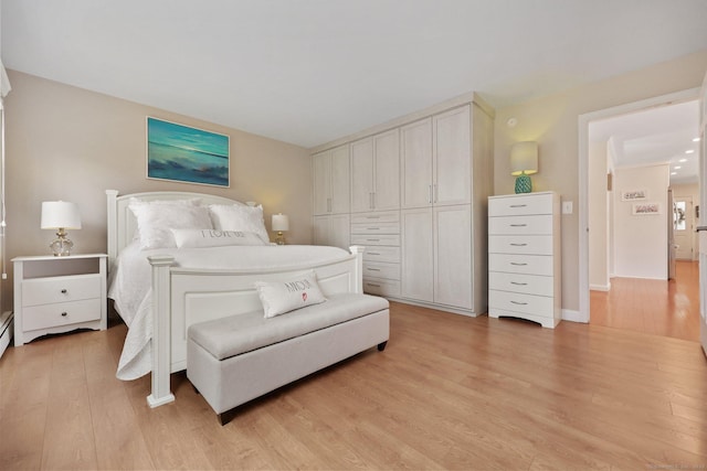 bedroom featuring light wood-style flooring