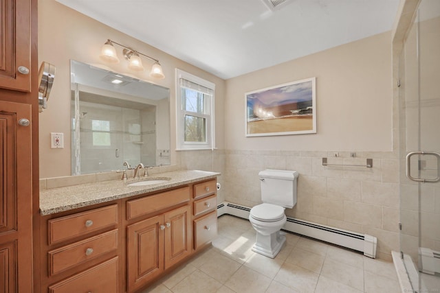 bathroom with a stall shower, a baseboard heating unit, and tile patterned floors