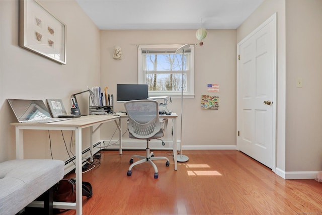 office space with baseboards and wood finished floors