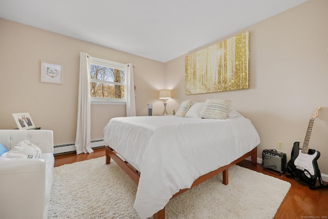 bedroom featuring a baseboard radiator and wood finished floors