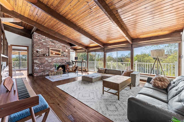living area featuring wood-type flooring, lofted ceiling with beams, wooden ceiling, and a wealth of natural light
