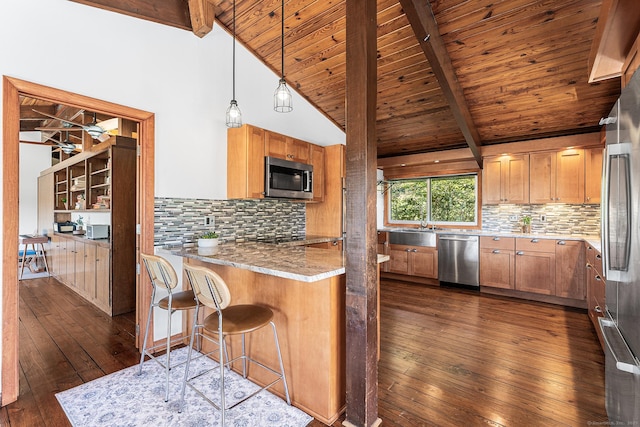 kitchen with dark wood finished floors, a sink, wooden ceiling, lofted ceiling with beams, and stainless steel appliances