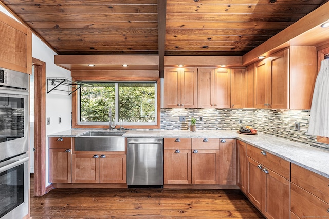 kitchen with dark wood-style flooring, a sink, stainless steel appliances, decorative backsplash, and wood ceiling