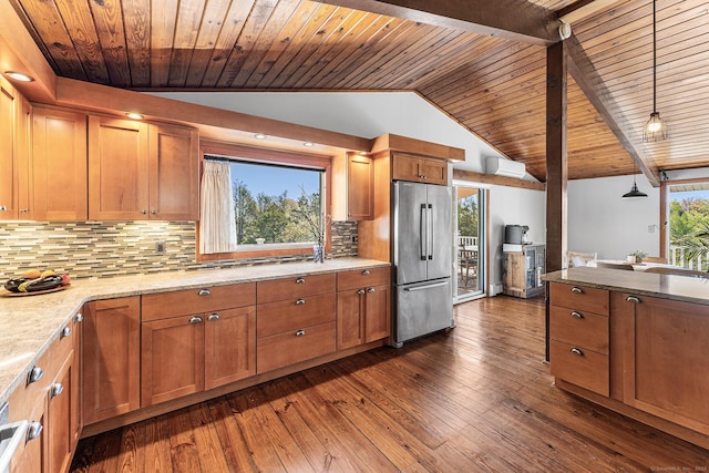 kitchen featuring a wall unit AC, brown cabinets, wooden ceiling, lofted ceiling, and stainless steel fridge
