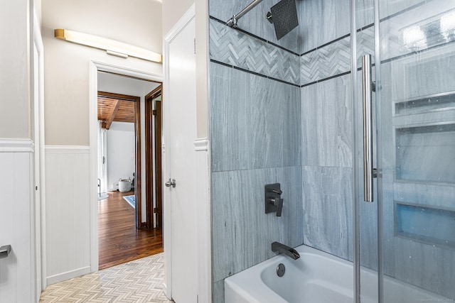 full bath with wainscoting and shower / washtub combination