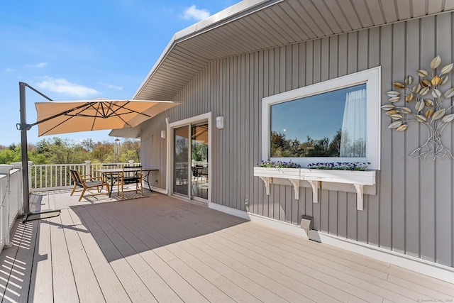 wooden terrace with outdoor dining area