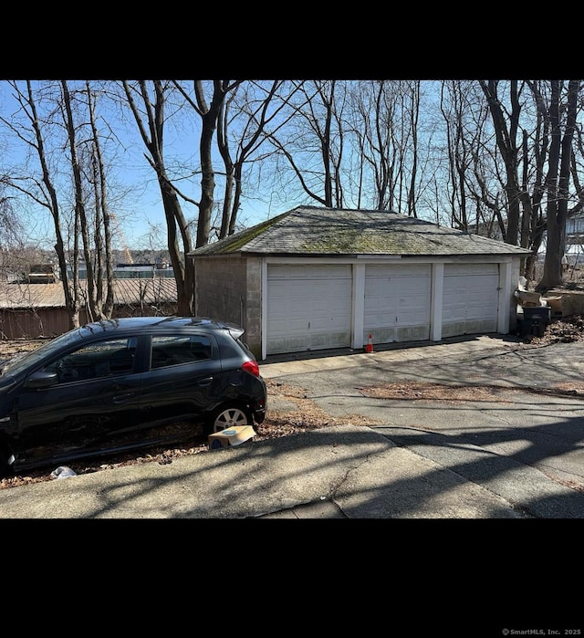 detached garage featuring fence
