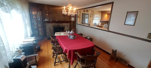 297 Whittemore Rd, Middlebury, CT 06762 - dining area featuring a chandelier, wood finished floors, and a fireplace