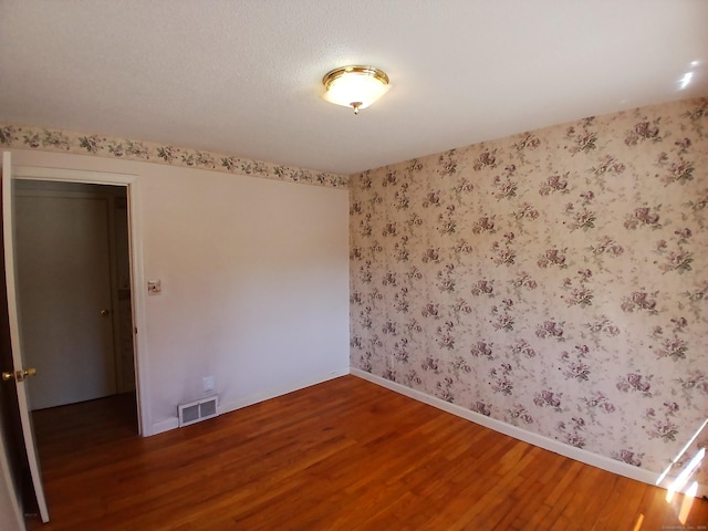 297 Whittemore Rd, Middlebury, CT 06762 - unfurnished room with wood finished floors, baseboards, and wallpapered walls