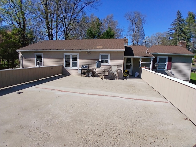 297 Whittemore Rd, Middlebury, CT 06762 - back of property featuring a patio area, fence, and a chimney