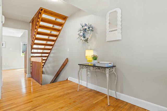 stairs featuring baseboards and wood finished floors