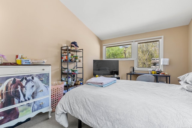 carpeted bedroom with lofted ceiling