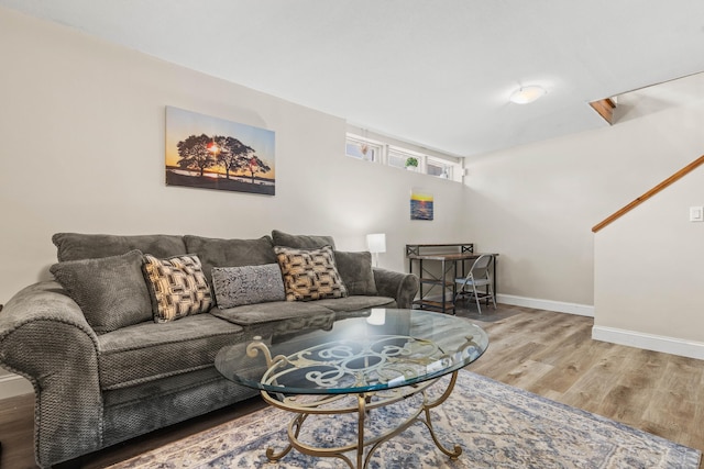 living area featuring baseboards and wood finished floors